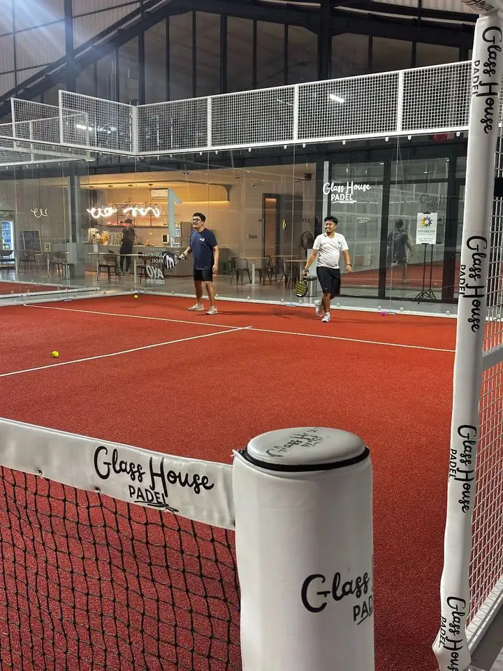 Court at Glass House Padel with the branded net and café behind the glass